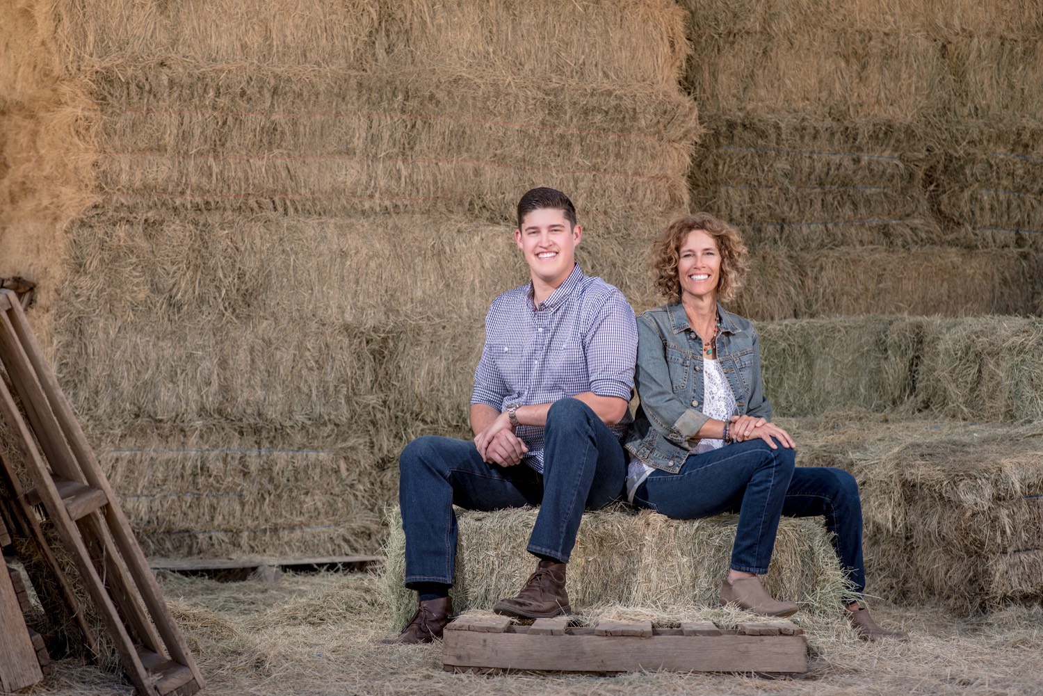 Robin Supalla and her son Shane sitting together on hay bales
